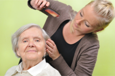 Caregiver combing the hair of a senior